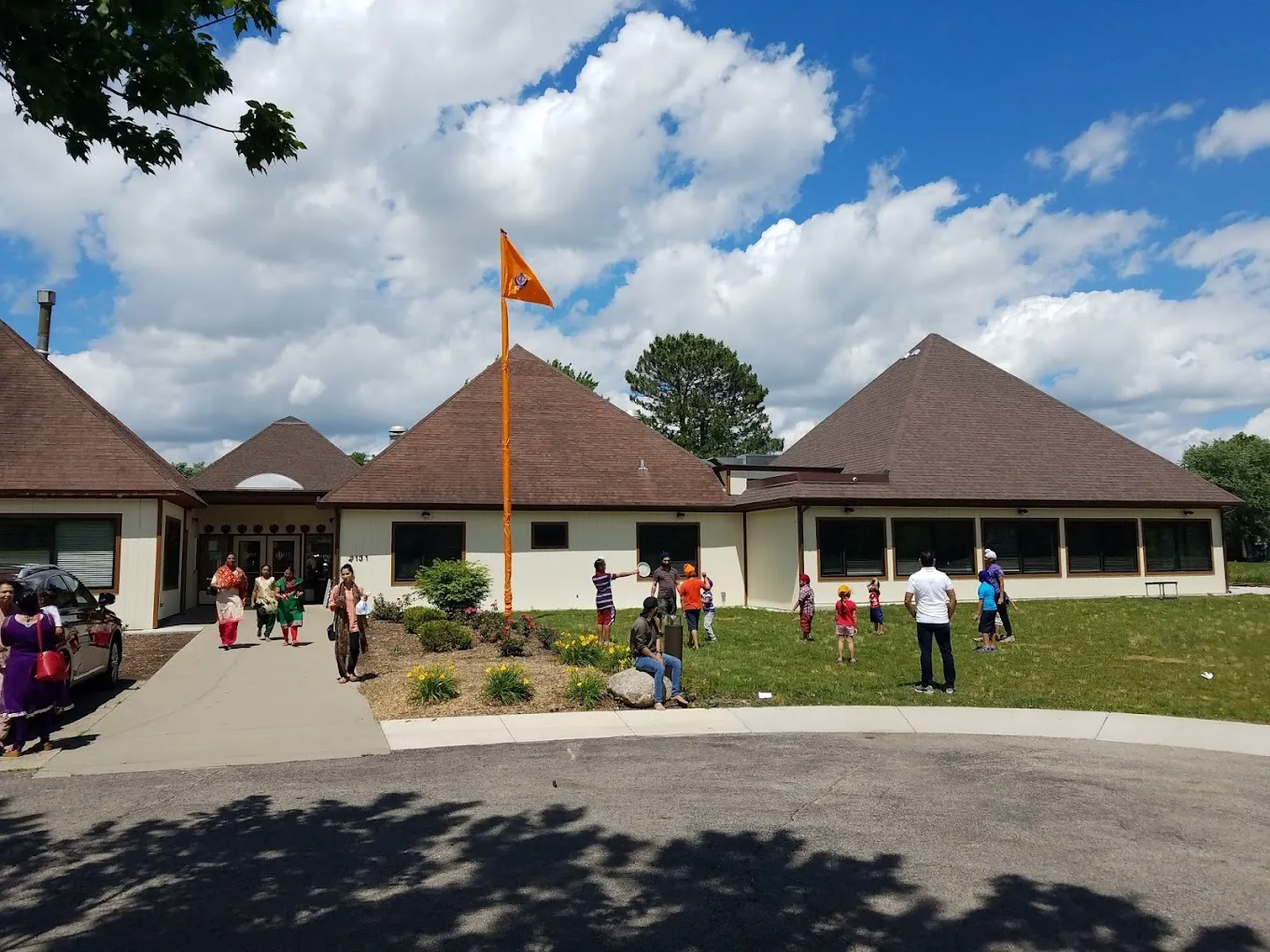The sangat outside the Gurdwara on a summer day